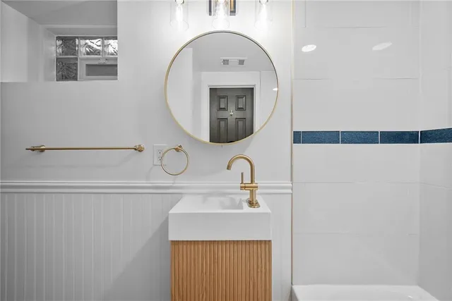 a bathroom with a sink and a mirror