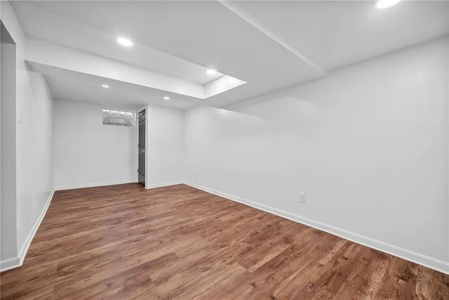 a view of an empty room with wooden floor