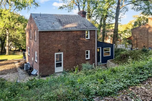 a view of a couches in front of house and swimming pool