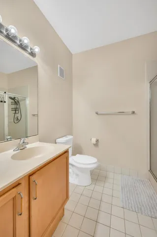 a bathroom with a sink a toilet and mirror