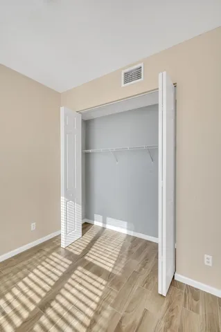 a view of a room with wooden floor and bathroom