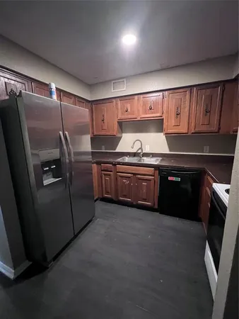 a kitchen with stainless steel appliances granite countertop a stove a refrigerator and a sink