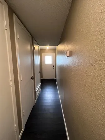 a view of hallway with wooden floor