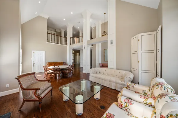 a view of a livingroom with wooden floor and a ceiling fan