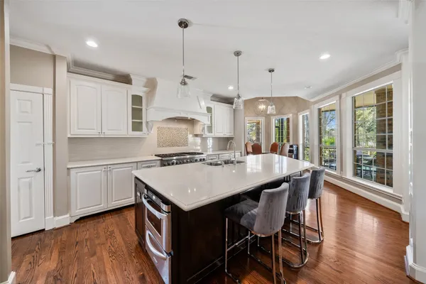 a bedroom with a bed and a flat tv screen on a dresser