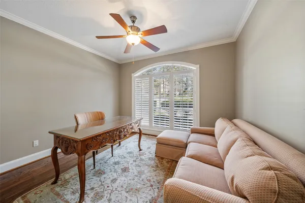 a living room with fireplace furniture and a large window
