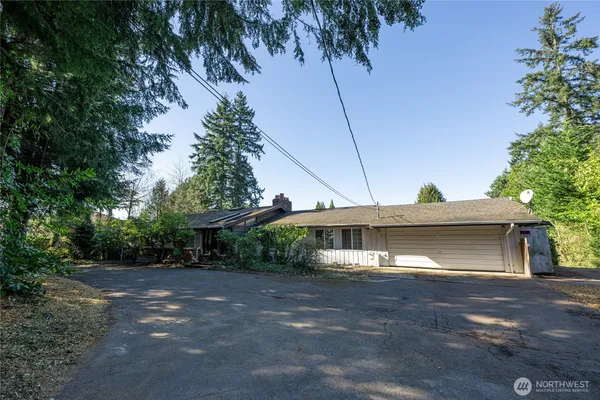 a front view of a house with a yard and a garage