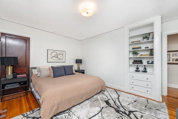 a bedroom with a bed and a television