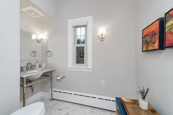 a bathroom with a toilet sink and mirror