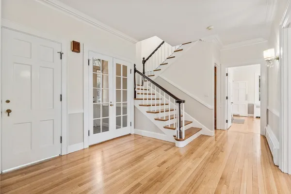 a view of entryway with wooden floor and stairs