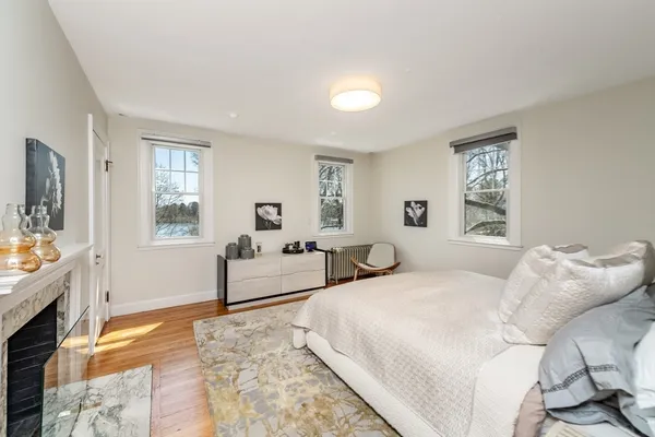a spacious bedroom with a large bed and a flat screen tv