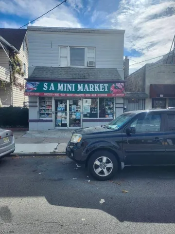 a front view of a building with parking space