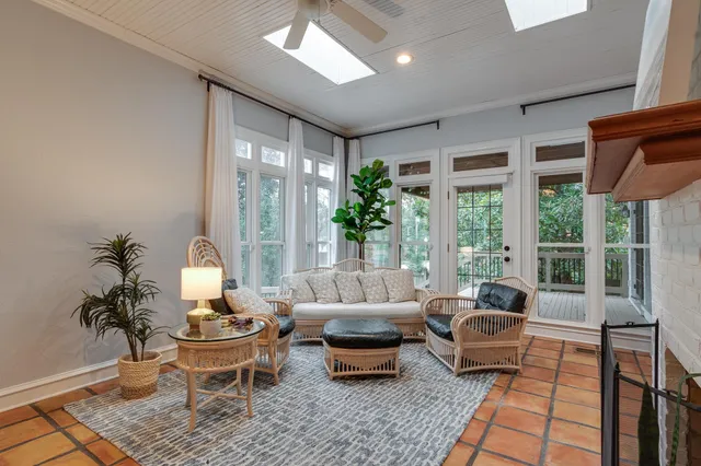 a living room with furniture and a potted plant
