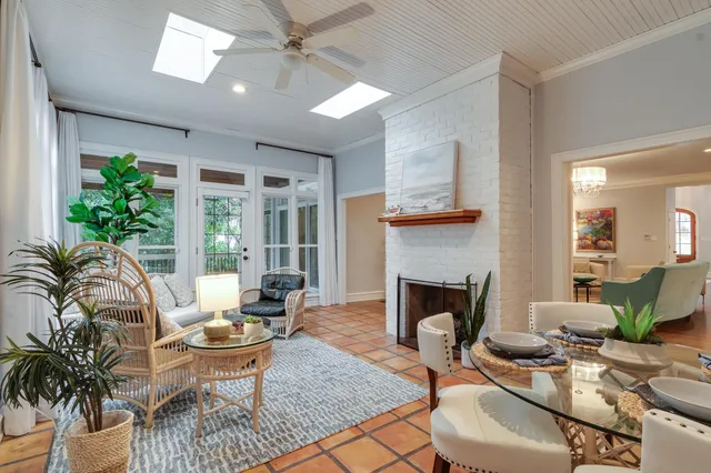 a living room with furniture a fireplace and a table