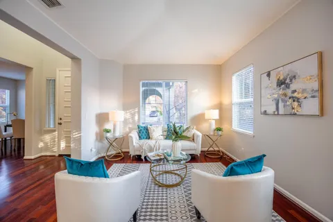 a view of a dining room with furniture wooden floor and chandelier
