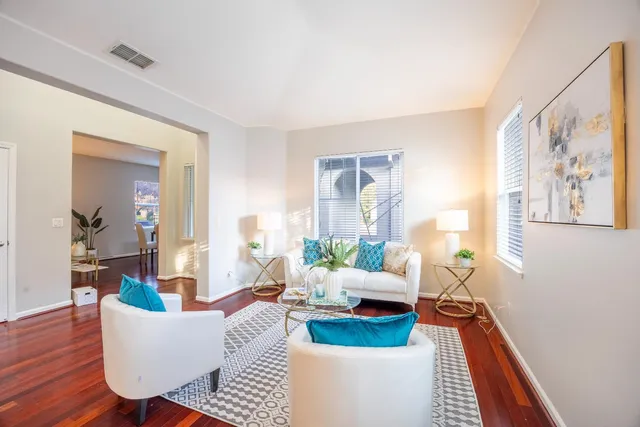 a view of a dining room with furniture wooden floor and chandelier