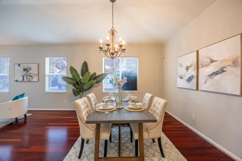 a view of a dining room with furniture wooden floor and chandelier