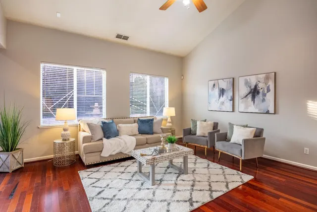 a living room with furniture and wooden floor