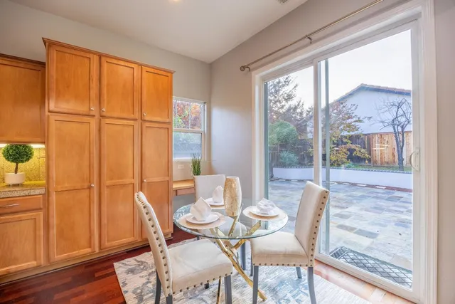 a kitchen with granite countertop cabinets stainless steel appliances a sink and a window