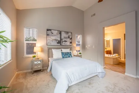 a bathroom with a tub sink and a mirror