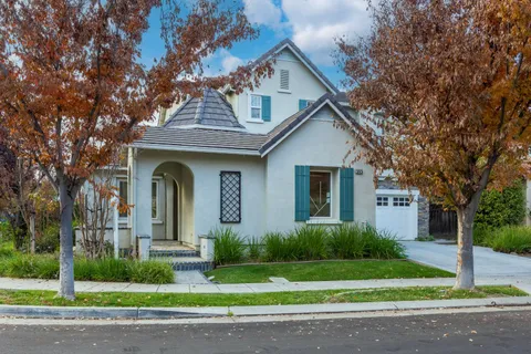 a front view of a house with a garden