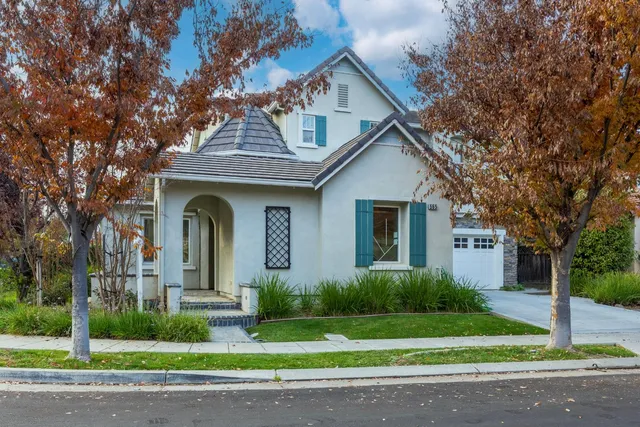 a front view of a house with a garden