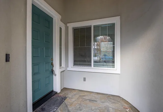 a view of a dining room with furniture a chandelier and wooden floor