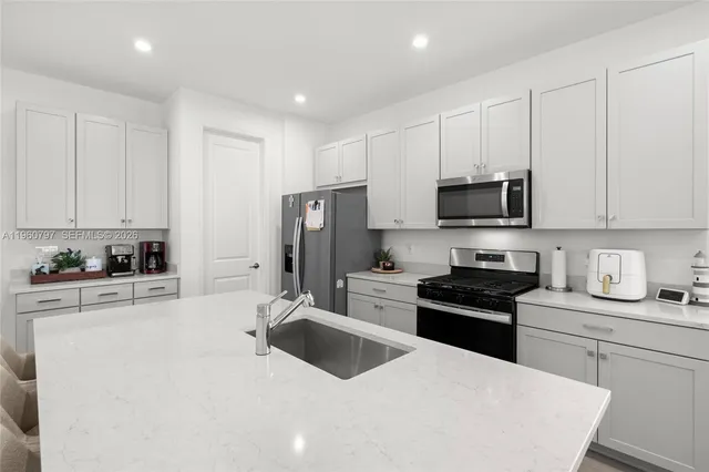 a kitchen with refrigerator and cabinets