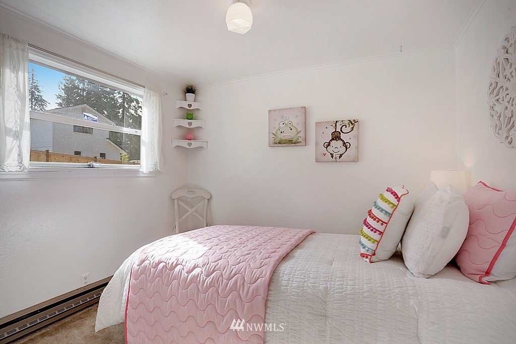 8729 236th Street Southwest Edmonds, WA 98026 - Photo 11 of 15 a bedroom with a bed and a painting on the wall