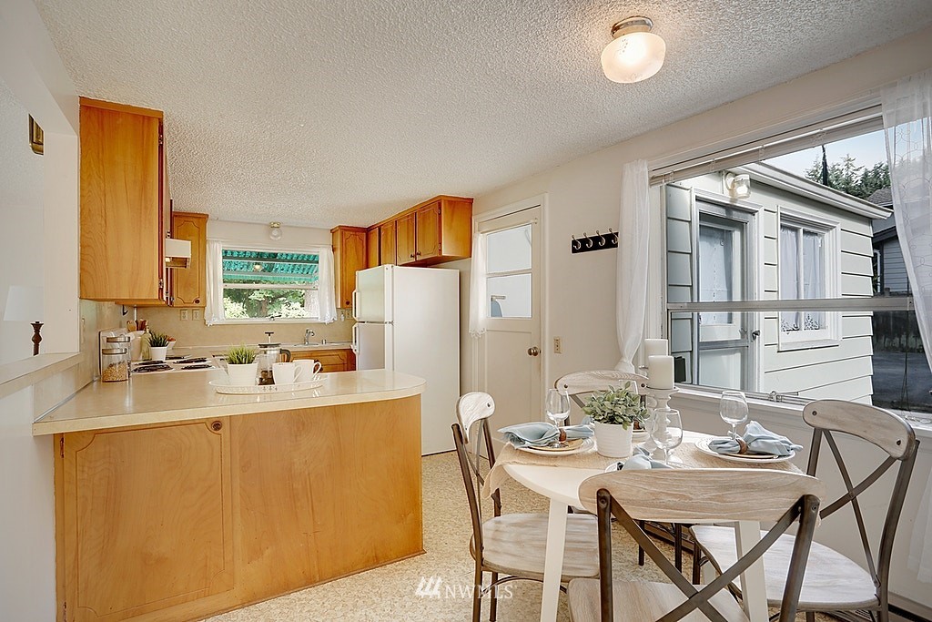 8729 236th Street Southwest Edmonds, WA 98026 - Photo 6 of 15 a view of a dining room with furniture and window