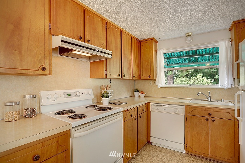 8729 236th Street Southwest Edmonds, WA 98026 - Photo 7 of 15 a kitchen with a sink a stove and cabinets