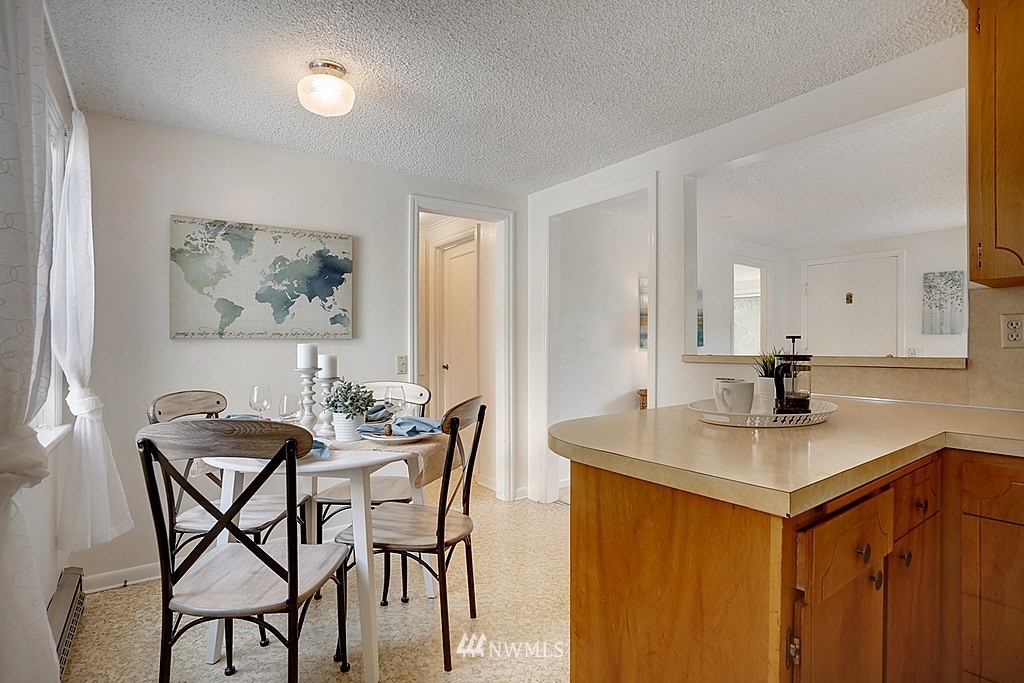 8729 236th Street Southwest Edmonds, WA 98026 - Photo 8 of 15 a view of a kitchen area with furniture and wooden floor