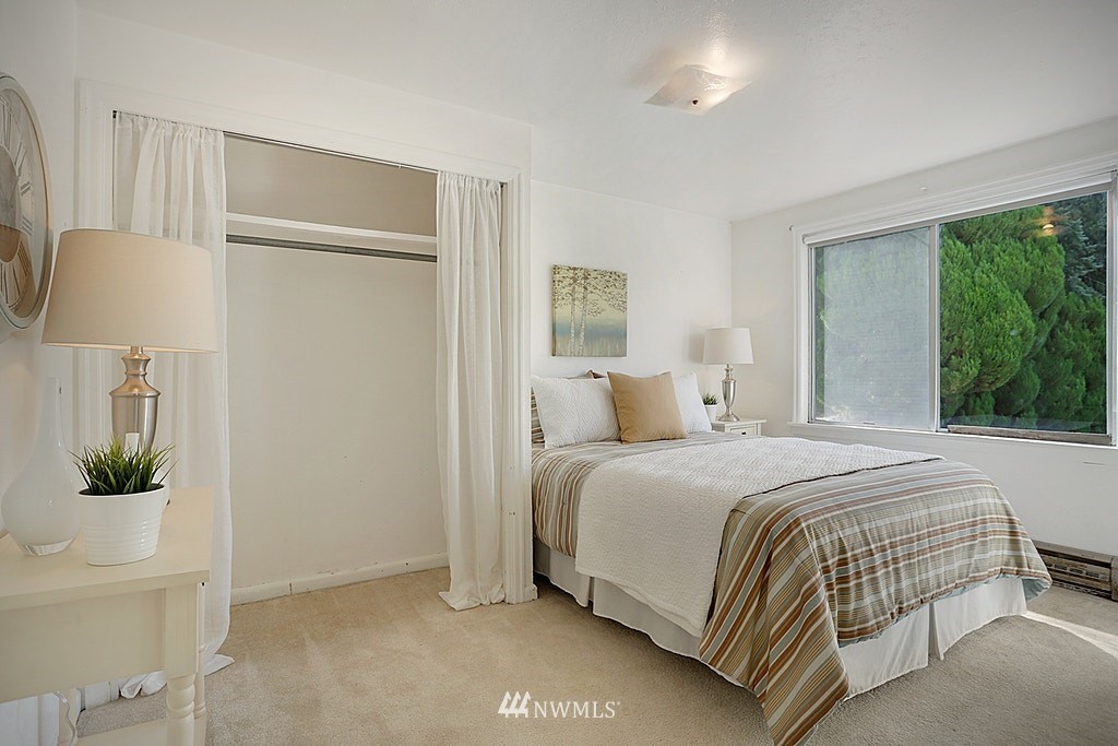 8729 236th Street Southwest Edmonds, WA 98026 - Photo 9 of 15 a bedroom with a bed and a lamp with window