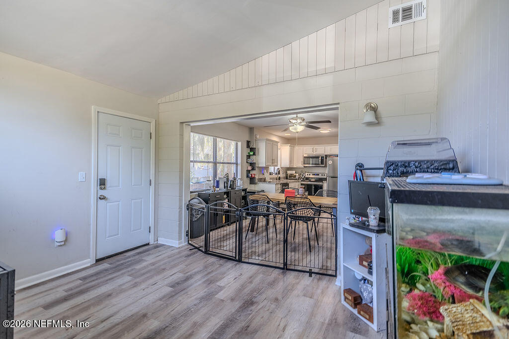 7580 Strato Road Jacksonville, FL 32210 - Photo 11 of 27 a view of a dining room with furniture and wooden floor