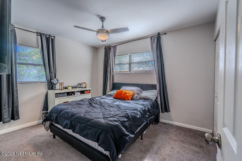 7580 Strato Road Jacksonville, FL 32210 - Photo 14 of 27 a bedroom with a bed and a window