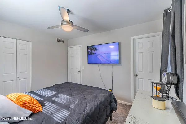 a bedroom with a bed and a chandelier