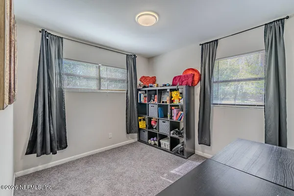 an empty room with toys and a window