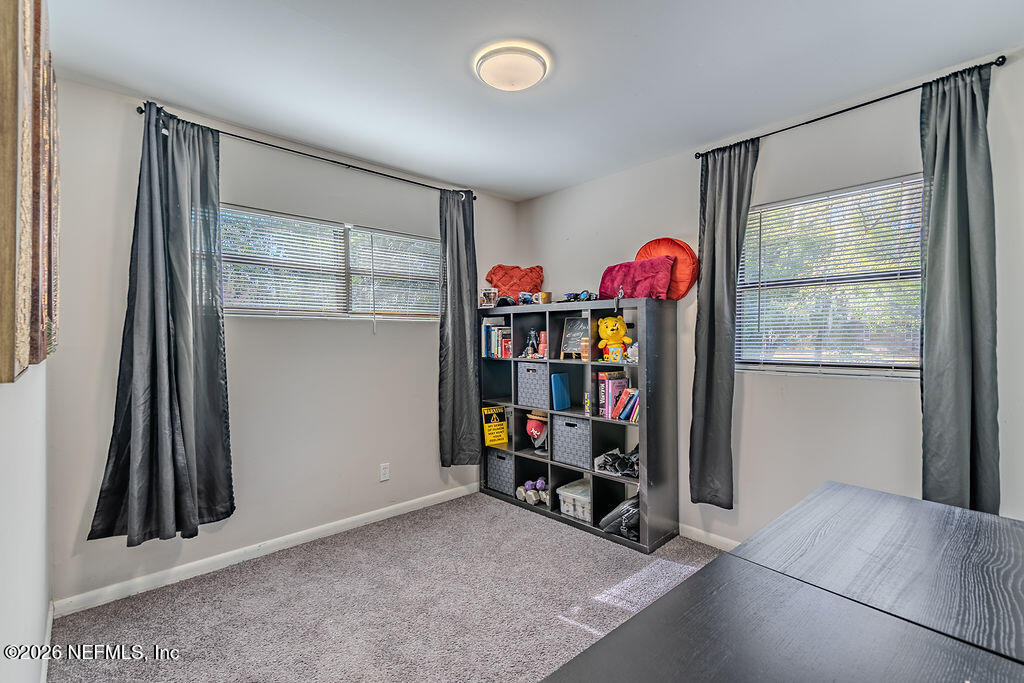 7580 Strato Road Jacksonville, FL 32210 - Photo 19 of 27 an empty room with toys and a window