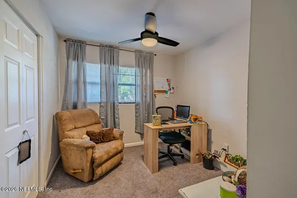 a work room with furniture and windows