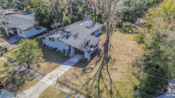 an aerial view of a house with a yard