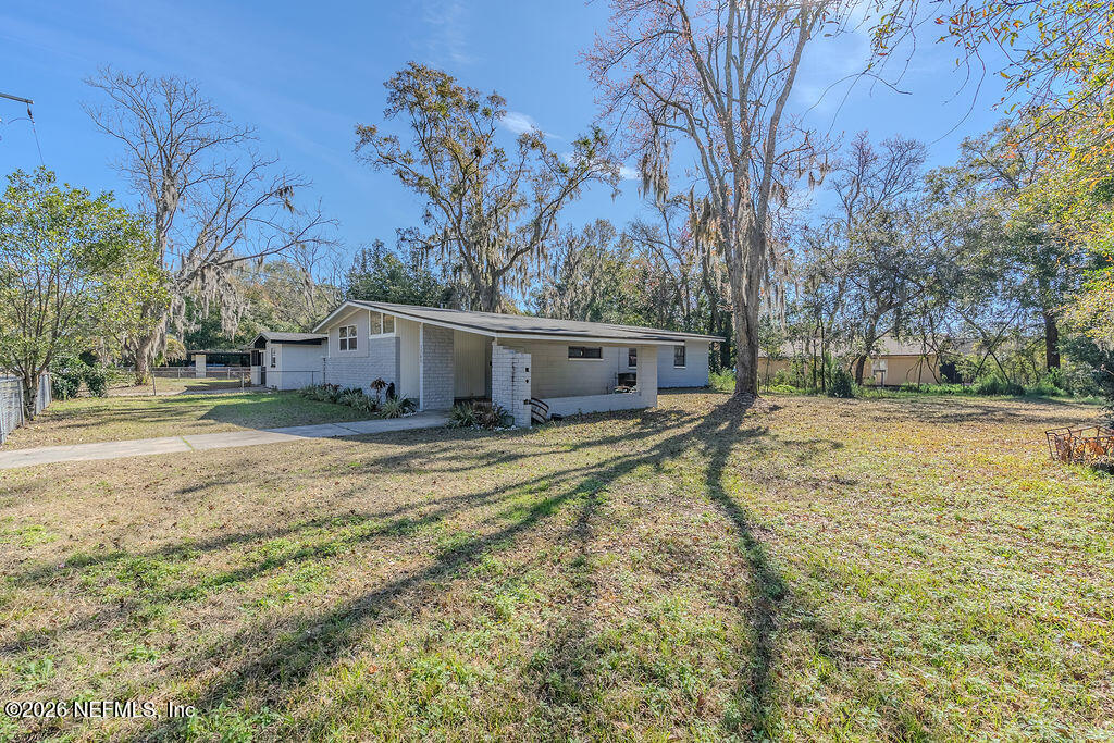 7580 Strato Road Jacksonville, FL 32210 - Photo 3 of 27 a view of a house with a yard covered in snow