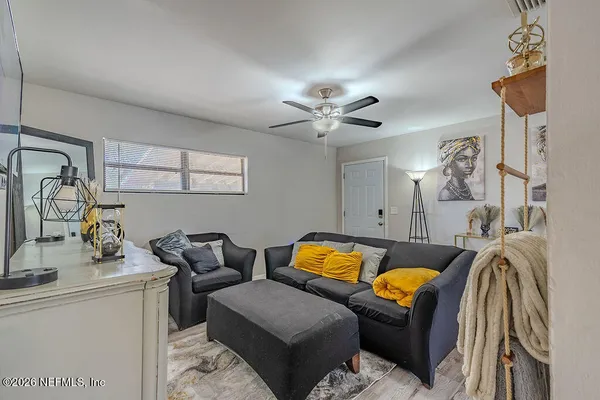 a living room with furniture and ceiling fan