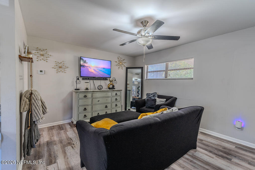 7580 Strato Road Jacksonville, FL 32210 - Photo 5 of 27 a living room with furniture and a flat screen tv