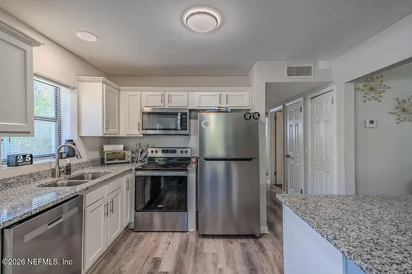 a kitchen with a refrigerator a sink and dishwasher