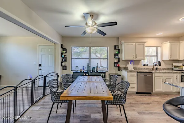 a living room with furniture a dining table and kitchen view