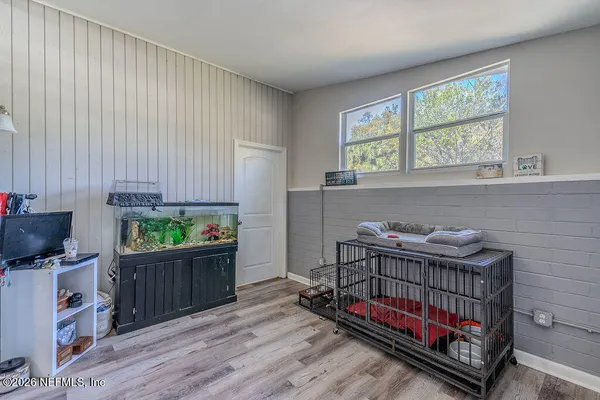 a bedroom with furniture and a window