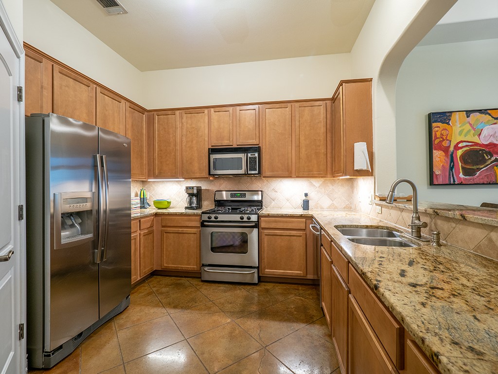 3609 Clawson Road, Unit B Austin, TX 78704 - Photo 7 of 28 Kitchen featuring an integrated stainless steel refrigerator, gas range, and microwave
