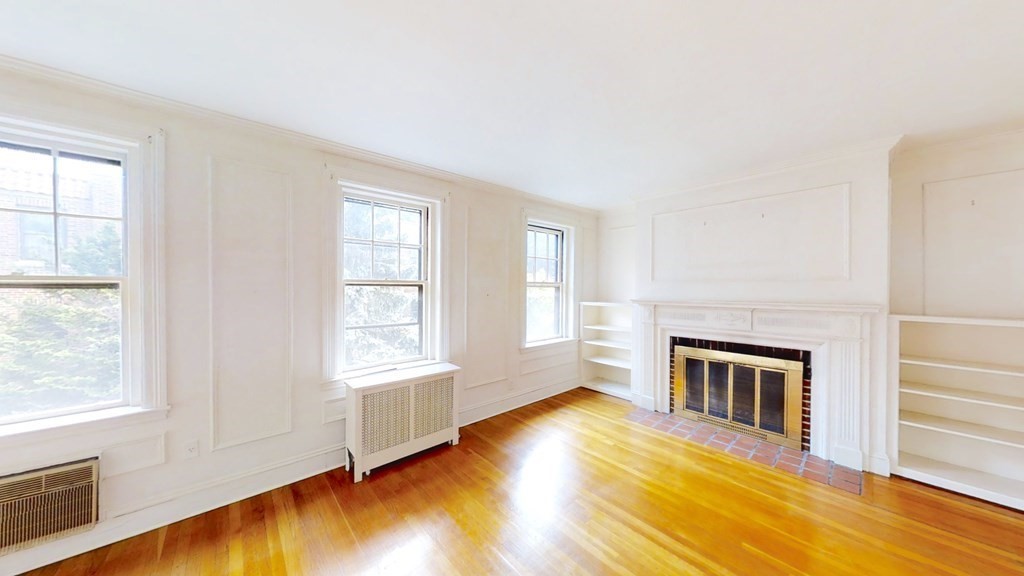 321 Tappan Street, Unit 6 Brookline, MA 02445 - Photo 1 of 14 a view of an empty room with wooden floor and a window