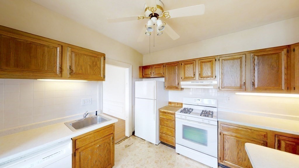 321 Tappan Street, Unit 6 Brookline, MA 02445 - Photo 11 of 14 a kitchen with a stove a sink and a refrigerator