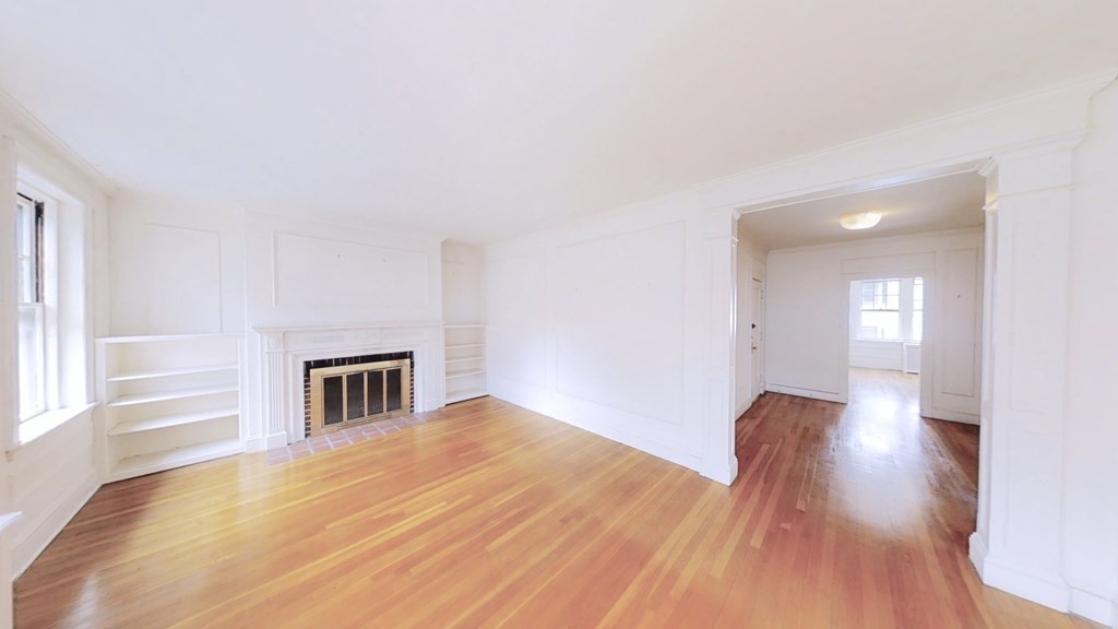 321 Tappan Street, Unit 6 Brookline, MA 02445 - Photo 2 of 14 a view of empty room with wooden floor and fan